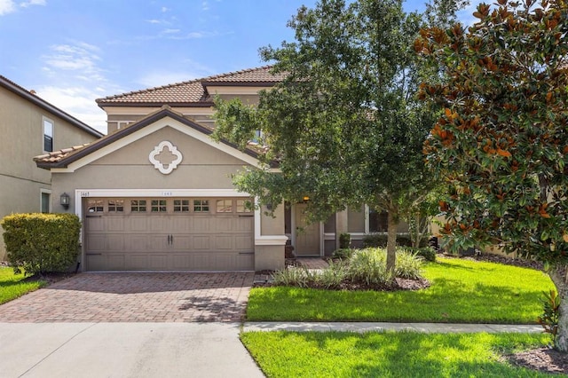 view of front of house with a front lawn and a garage