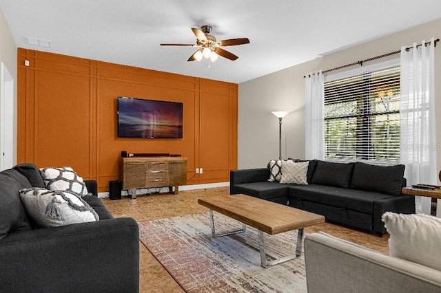 living room with light tile patterned floors and ceiling fan