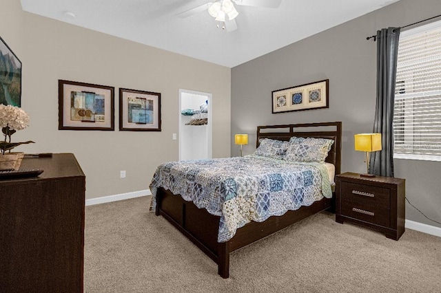 bedroom with ceiling fan and light carpet