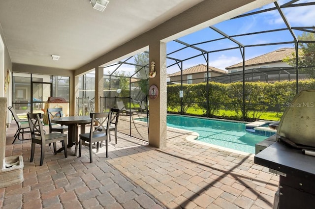 view of swimming pool featuring glass enclosure and a patio area