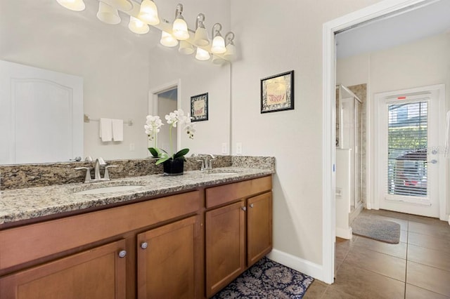 bathroom featuring tile patterned floors, vanity, and walk in shower