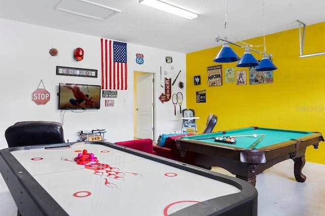 game room featuring concrete flooring, a textured ceiling, and pool table