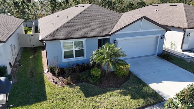 view of front facade featuring a front yard and a garage