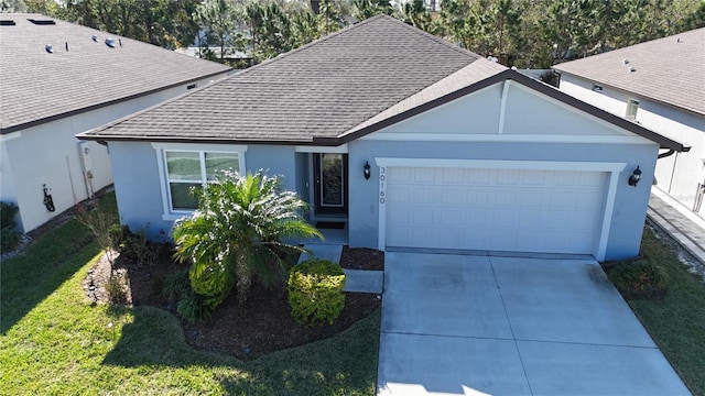 view of front of house with a garage and a front lawn