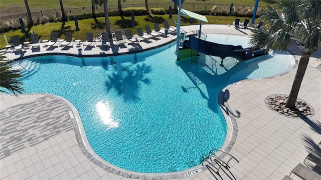 view of pool with a yard and a patio