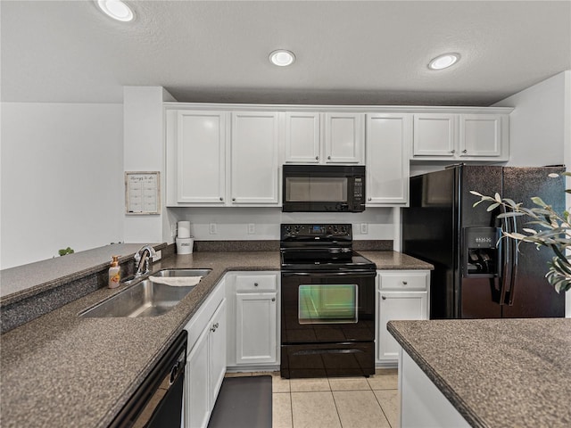 kitchen with black appliances, light tile patterned flooring, white cabinets, and sink