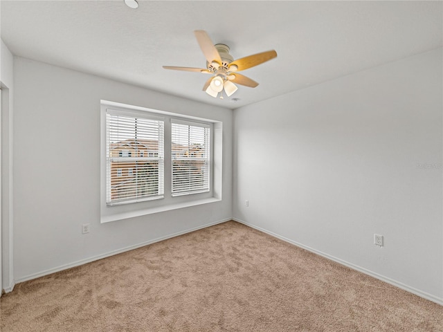 empty room with ceiling fan and light carpet