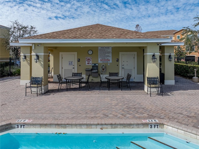 back of property with a patio and a community pool