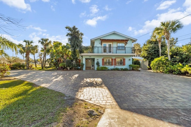 view of front of property with a balcony and a front yard