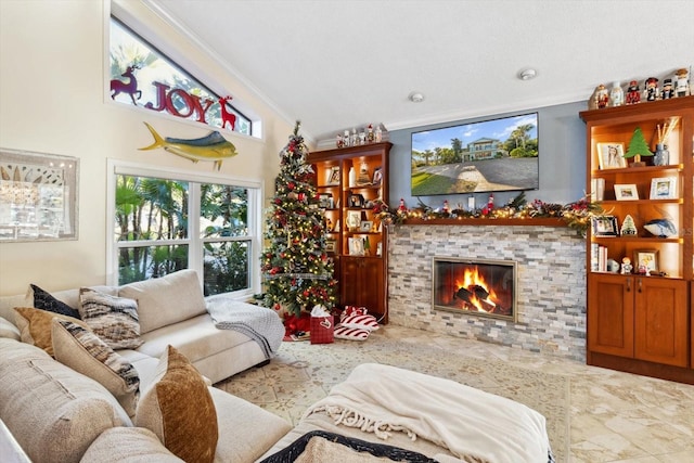 living room featuring a stone fireplace, crown molding, and vaulted ceiling