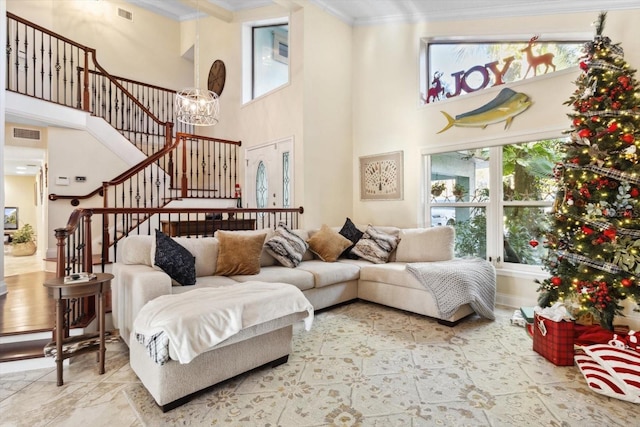 living room with crown molding and a towering ceiling