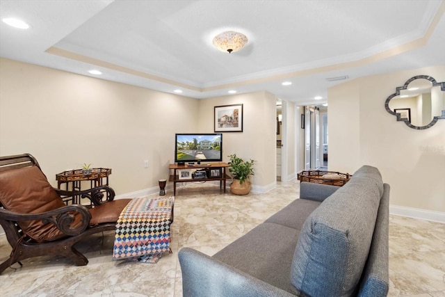 living room with a tray ceiling and ornamental molding