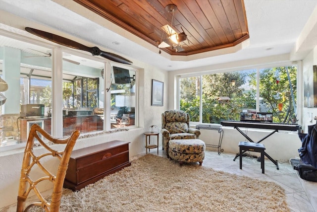 sunroom with a raised ceiling, a wealth of natural light, and wooden ceiling