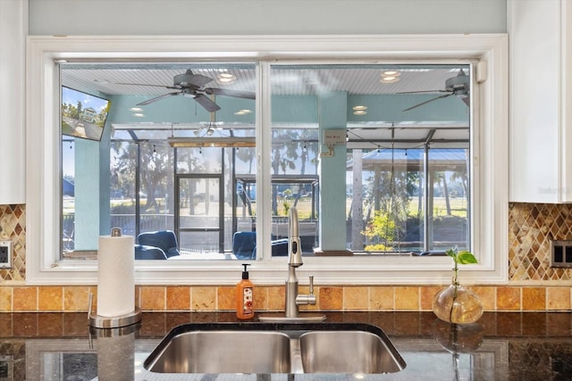 kitchen with backsplash and dark stone countertops