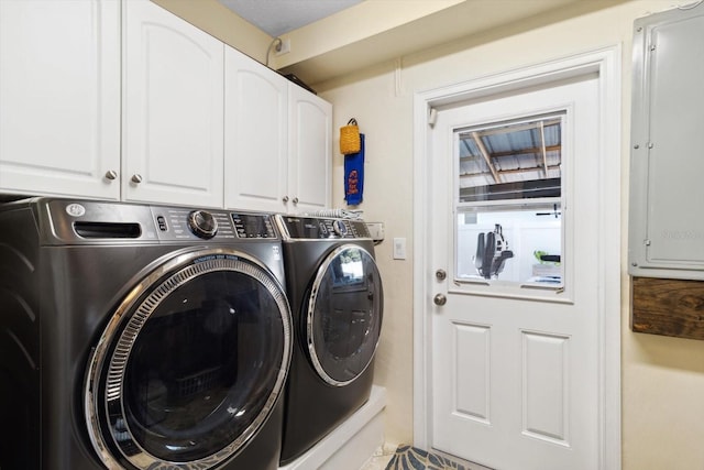 washroom with cabinets, independent washer and dryer, and electric panel