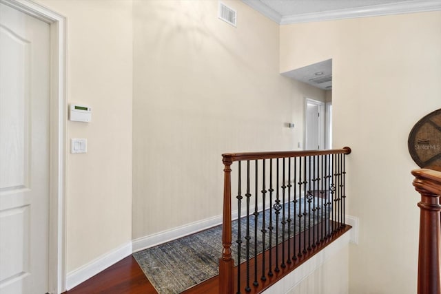 hall with hardwood / wood-style floors and crown molding