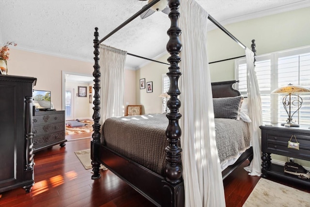 bedroom with dark hardwood / wood-style flooring, a textured ceiling, ceiling fan, and ornamental molding