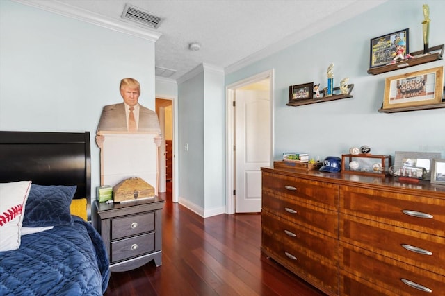 bedroom featuring a textured ceiling, dark wood-type flooring, and crown molding