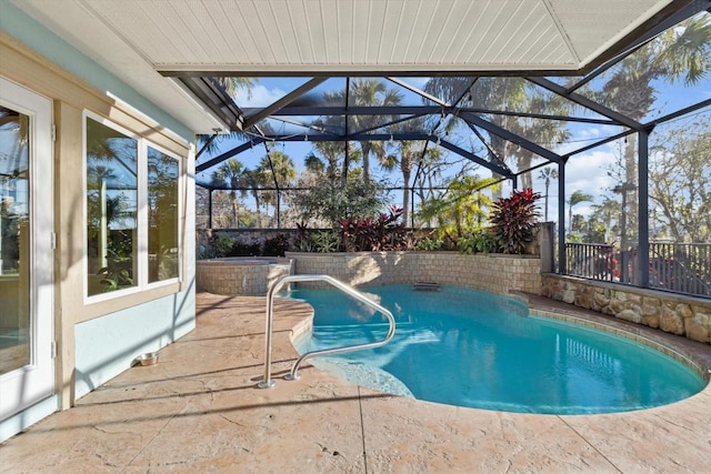 view of pool featuring glass enclosure and a patio