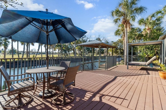 deck featuring a gazebo and a water view