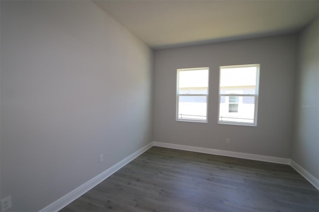 empty room featuring dark hardwood / wood-style flooring