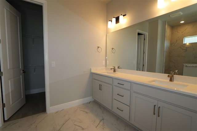 bathroom featuring a tile shower and vanity