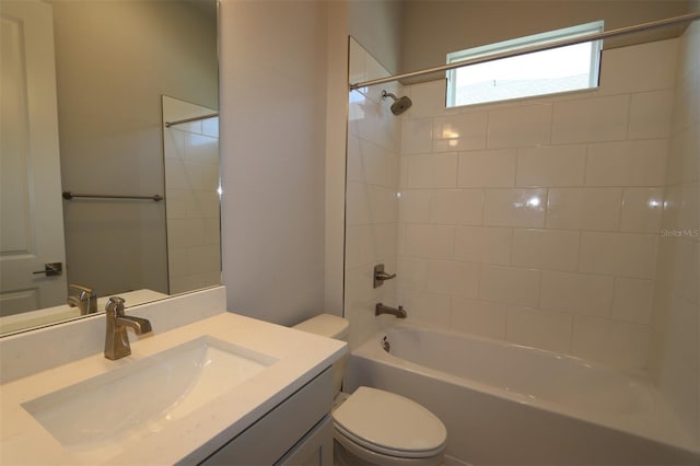 full bathroom featuring vanity, toilet, and tiled shower / bath