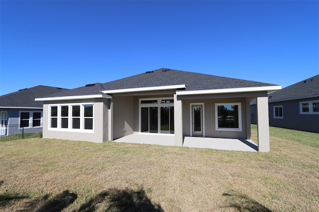 back of property featuring a patio area and a yard