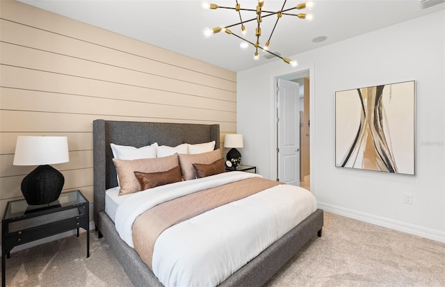 bedroom featuring wood walls, carpet, and a chandelier