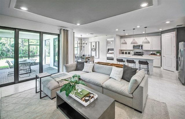 living room featuring light tile patterned floors and a chandelier