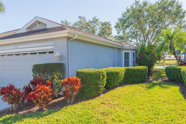 view of side of property with a garage and a yard