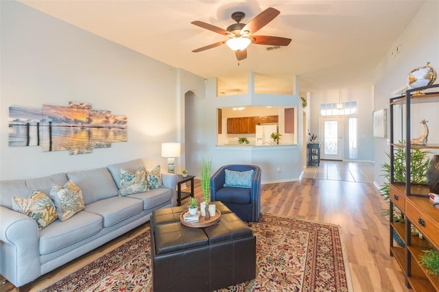 living room featuring light hardwood / wood-style flooring and ceiling fan