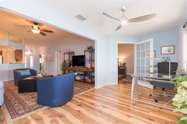 living room featuring ceiling fan and wood-type flooring