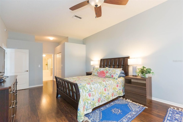 bedroom featuring dark wood-type flooring, ceiling fan, ensuite bathroom, and a closet