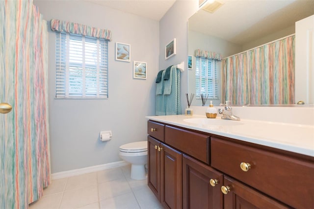 bathroom with tile patterned floors, vanity, and toilet