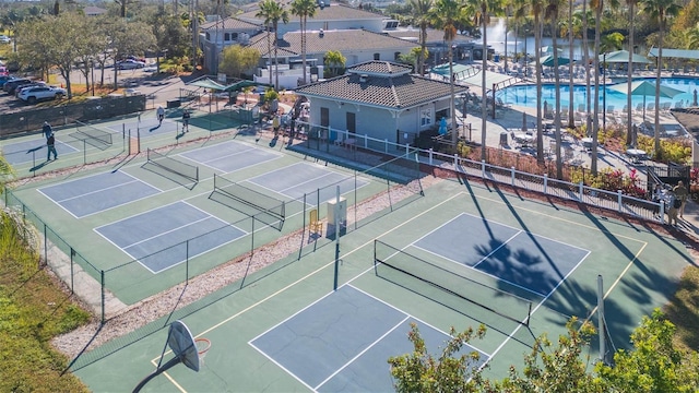 view of sport court featuring a community pool