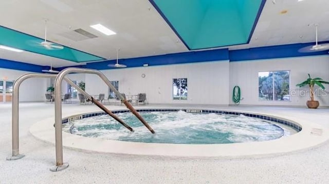 view of swimming pool featuring an indoor hot tub