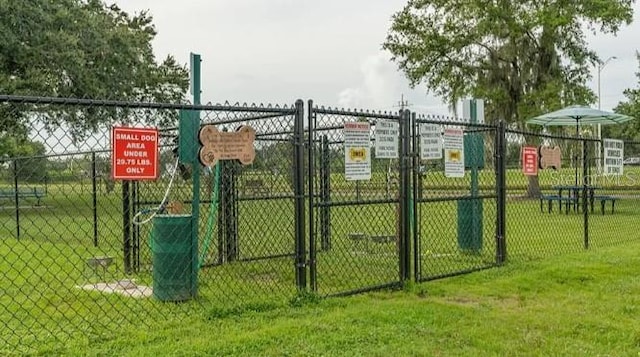 view of gate featuring a lawn