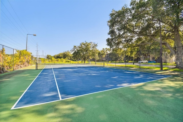 view of sport court featuring fence