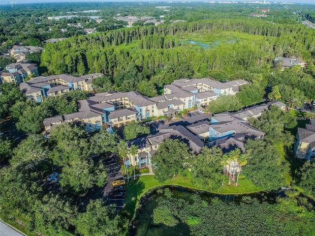 bird's eye view featuring a forest view, a residential view, and a water view