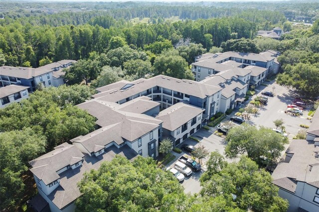 birds eye view of property with a residential view and a view of trees