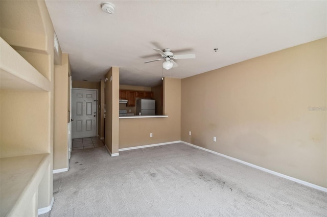 unfurnished living room featuring light carpet, baseboards, and a ceiling fan