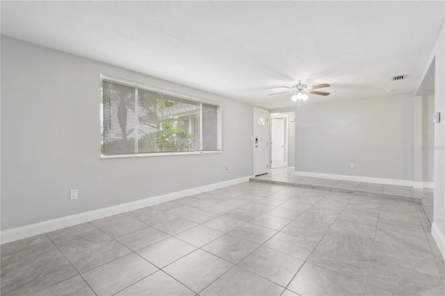 unfurnished room featuring light tile patterned floors and ceiling fan