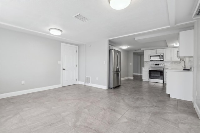 unfurnished living room featuring sink