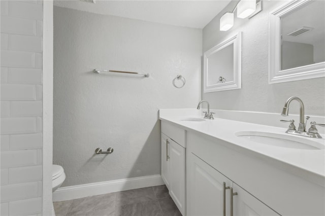 bathroom featuring tile patterned flooring, vanity, and toilet