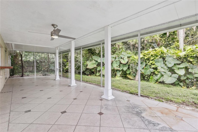 unfurnished sunroom featuring a wealth of natural light and ceiling fan