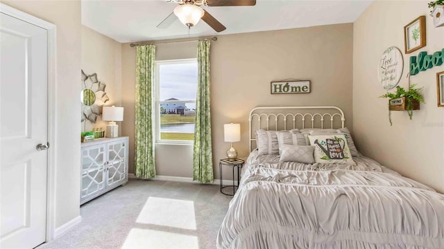 bedroom with ceiling fan and light carpet