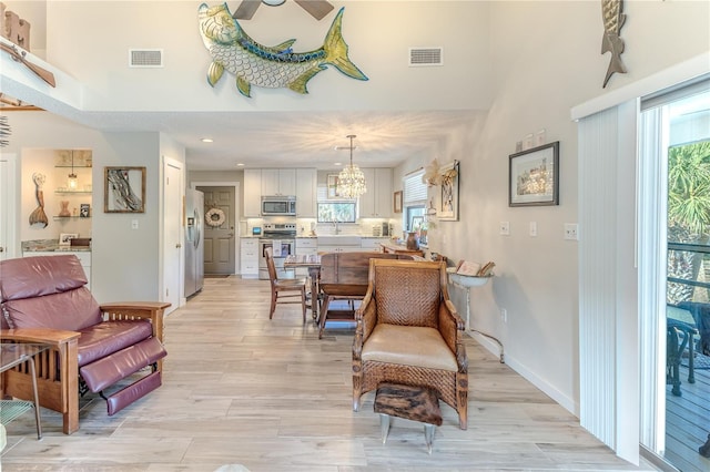 interior space with light hardwood / wood-style flooring and ceiling fan with notable chandelier