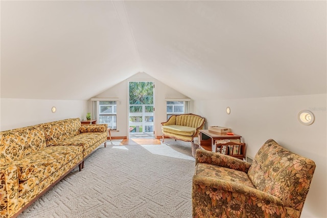 carpeted living room with lofted ceiling