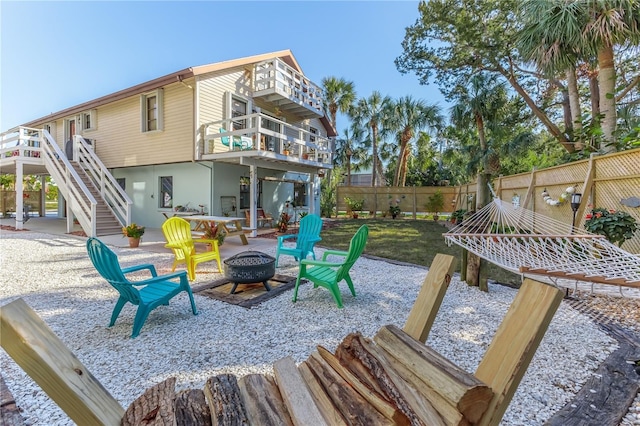 view of patio featuring a balcony and an outdoor fire pit